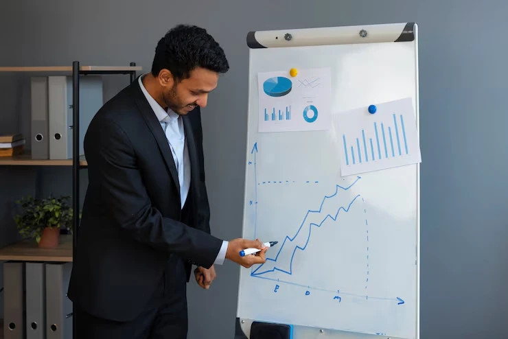 Investment strategist analyzing growth charts and performance data on presentation board