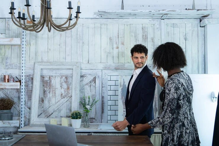 Property professionals discussing refurbishment plans with design materials and blueprints