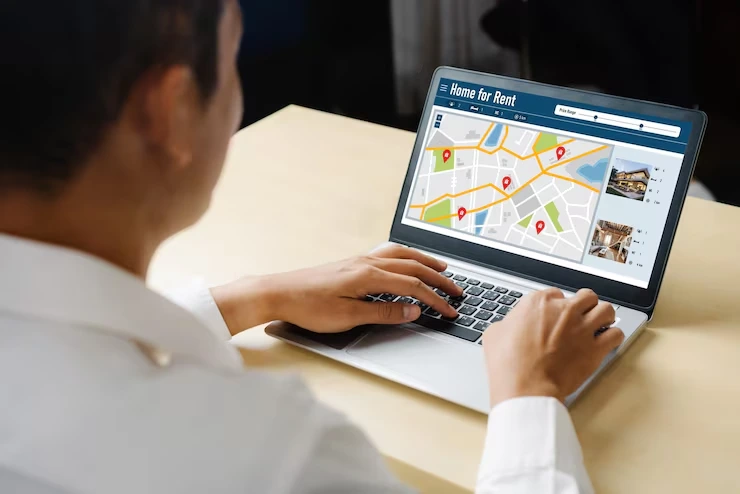 Property analyst using digital mapping platform to review rental properties with location markers