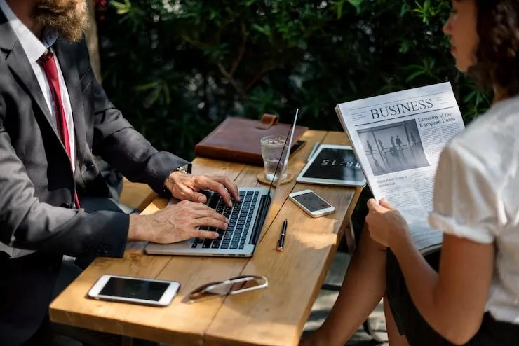 Business meeting outdoors with technology.